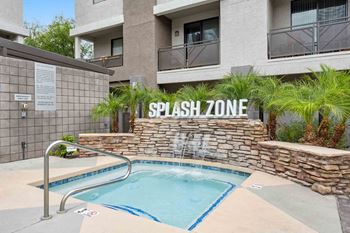 A pool with a sign that says splash zone.